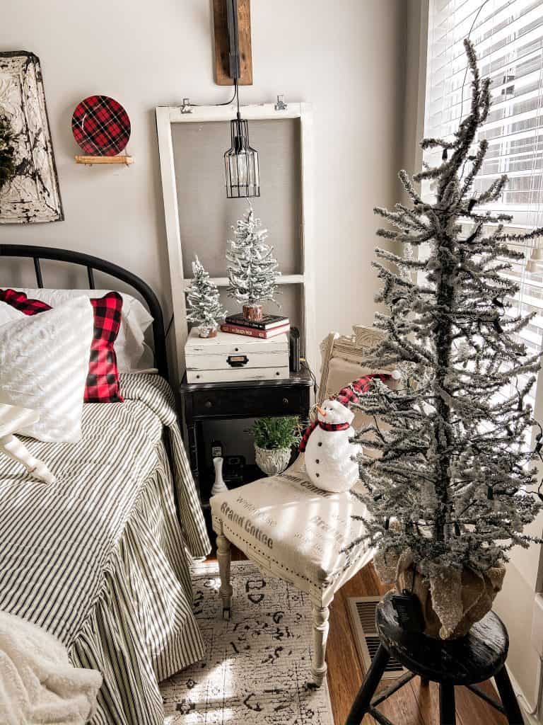 Bedroom decorated for Christmas with frosted mini trees and snowmen