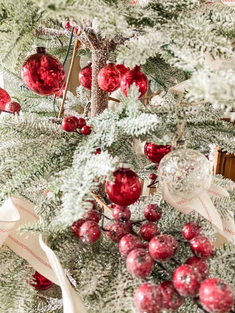 Frosted Farmhouse style tree with red berries and glass ornaments. 