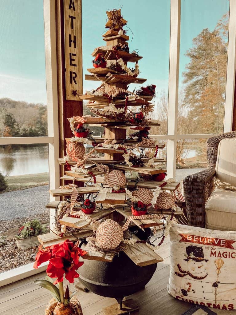 DIY Shiplap Christmas Tree made for reclaimed wood filled with DIY red ticking ball ornaments and red birds