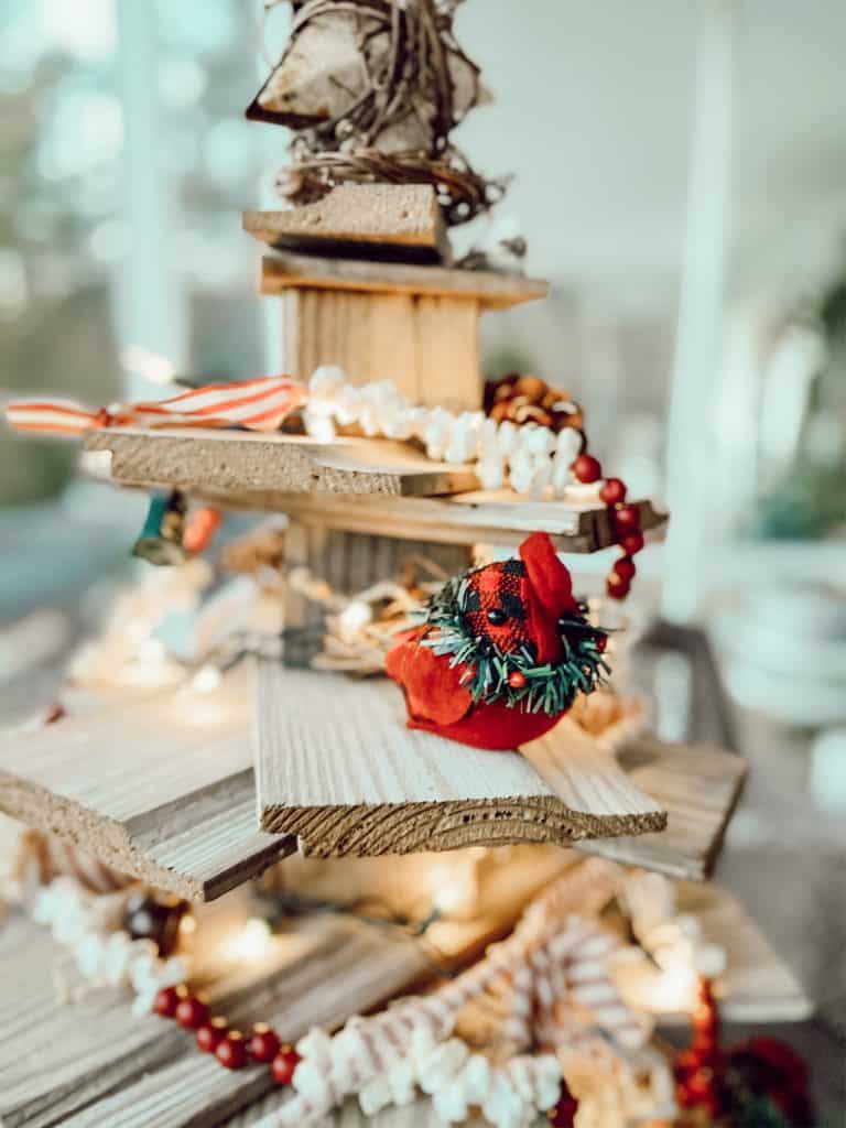 DIY Shiplap Wooden Christmas Tree with popcorn garland and red birds. 