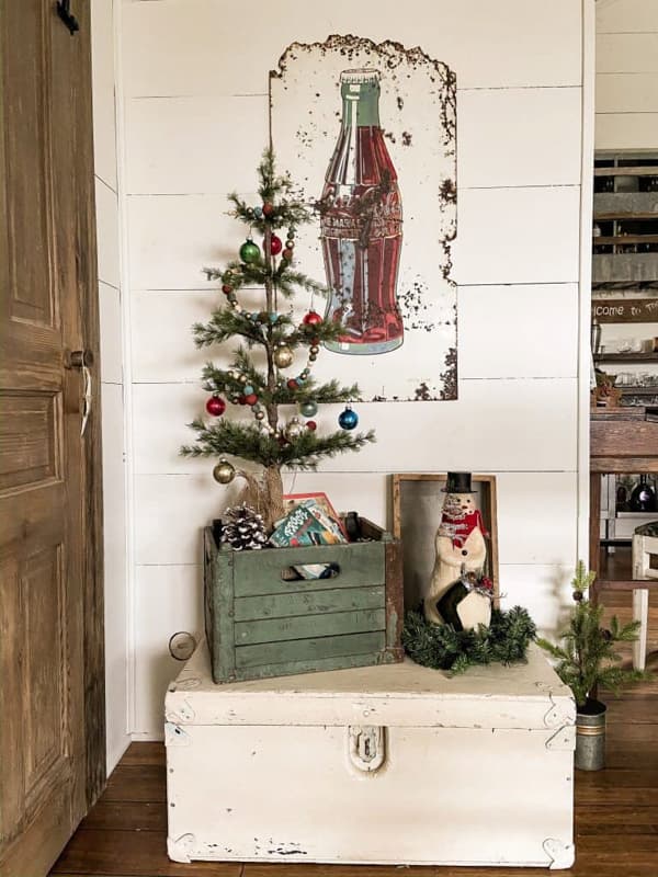 Vintage Wooded Crate with mini Christmas Tree. Vintage Coke sign.