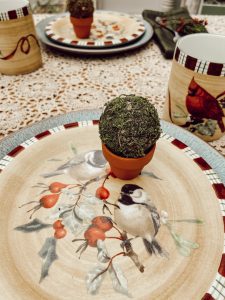 Vintage bird dishes and clay pot with mini moss ball for tablescape.