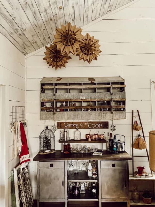 Paper bag snowflakes over DIY bar in industrial style farmhouse loft.