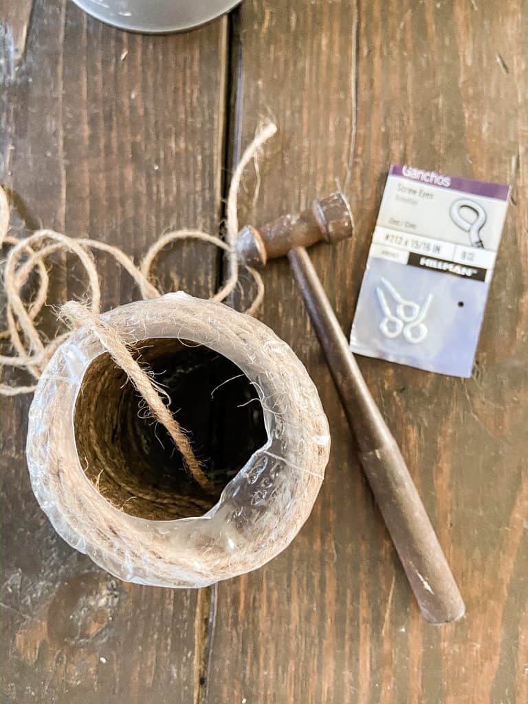 Add eye screws to wooden hearts for hanging. Use jute twine to hang hearts.