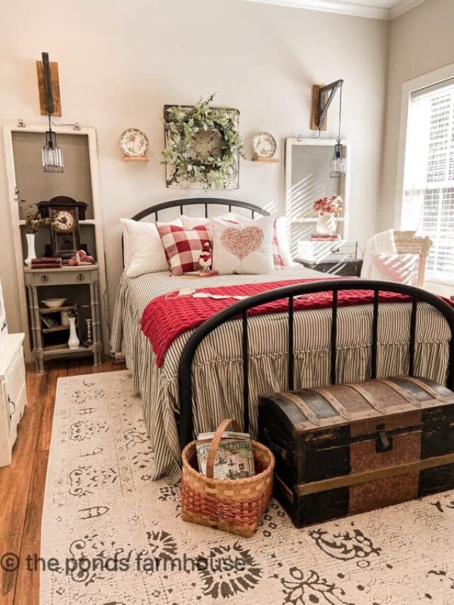 Farmhouse guest bedroom with iron bed, Valentine's pillows.