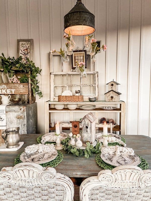 Easter tablescape with placemats and Easter rabbit plates. Screened porch decorated for Easter.