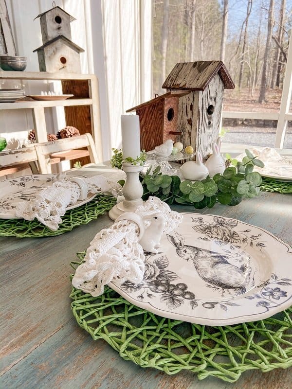 Easter Table setting with black and white dishes and green thrift store placemats.