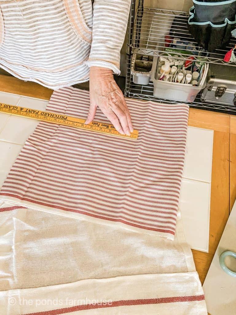 Measure red and white ticking fabric for the apron pocket and ties.