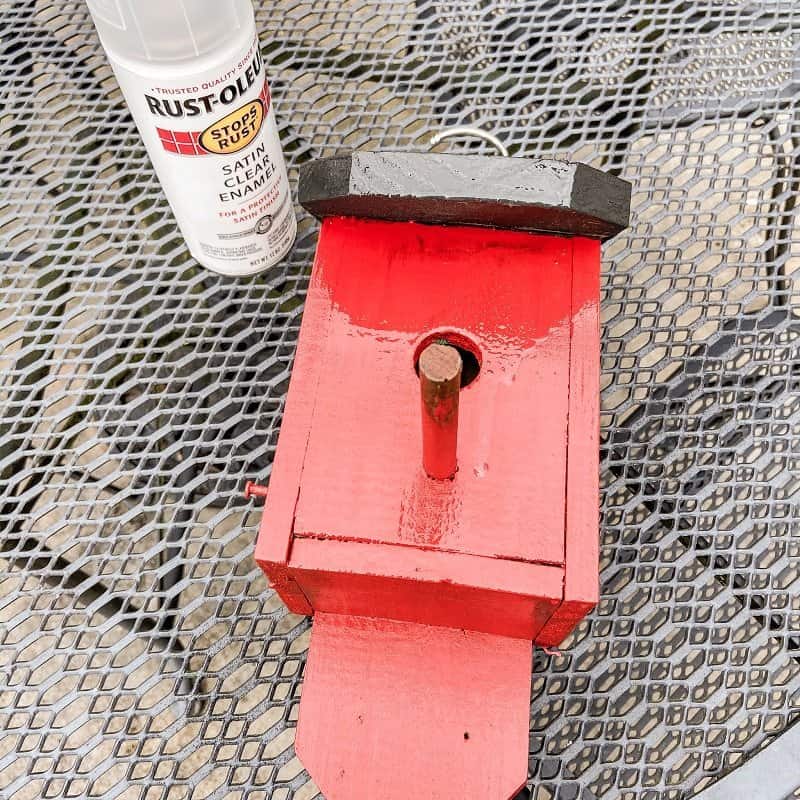 seal red birdhouse with protective paint finish.