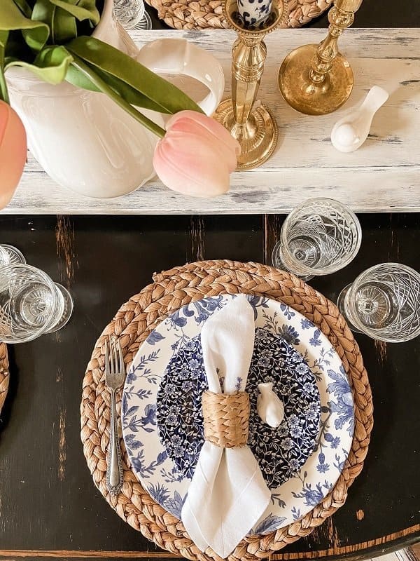 Spring Dinner table Setting with blue and white dishes and pink tulips.