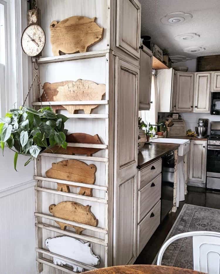Create a plate rack on the side of a cabinet with pig cutting boards displayed.