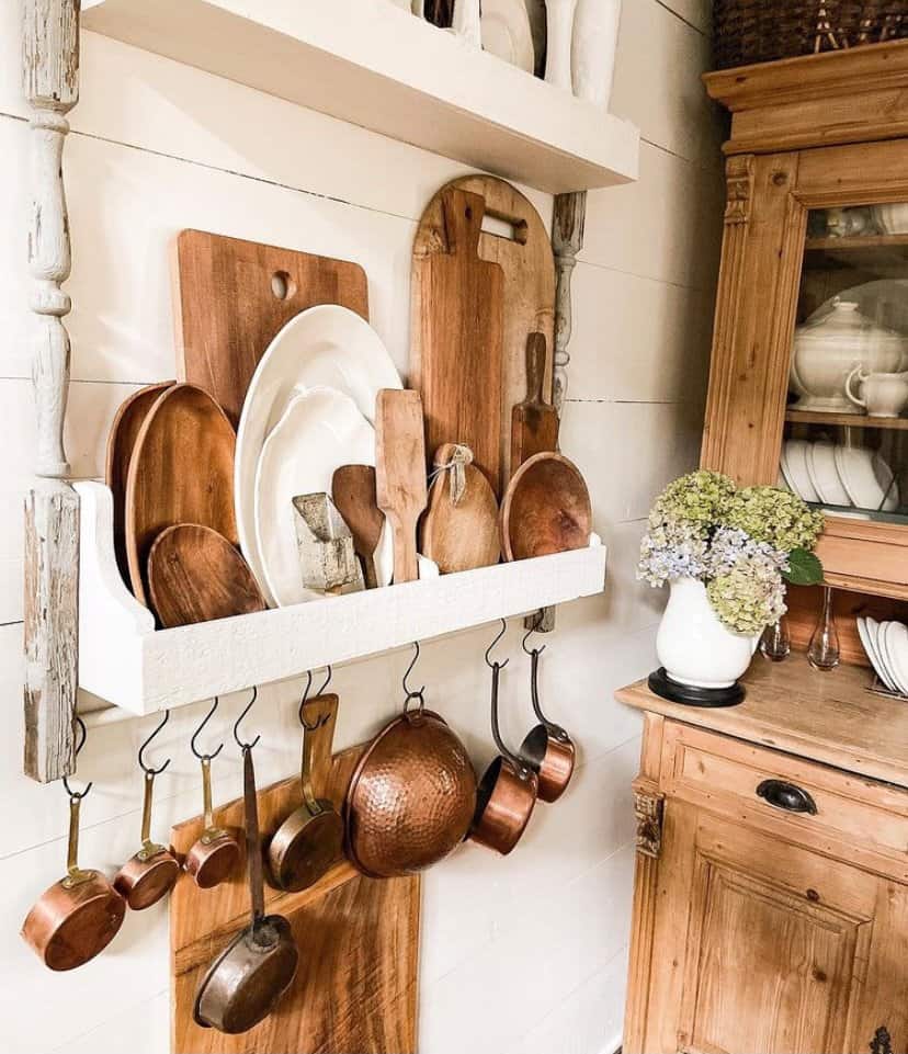 Decorate a DIY Plate Rack with layers of wooden bowls, cutting boards and vintage copper.  Hydrangeas in ironstone pitcher on hutch.