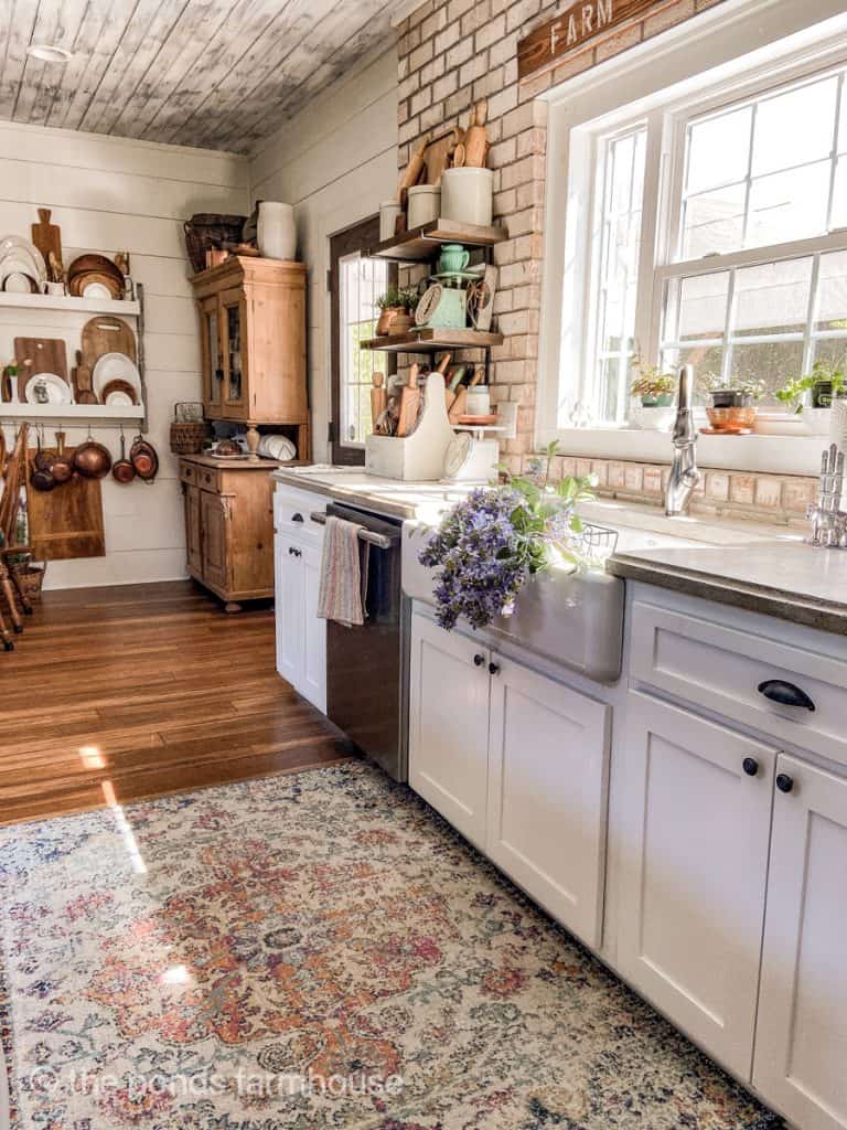 Ideas for Decorating a Farmhouse Kitchen with shaker style cabinets and warm woods and whites.  Concrete Countertops.