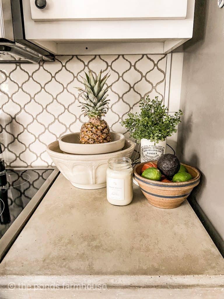 Stack collected vintage bowls on kitchen counter for fresh fruits and veggies on concrete counter tops