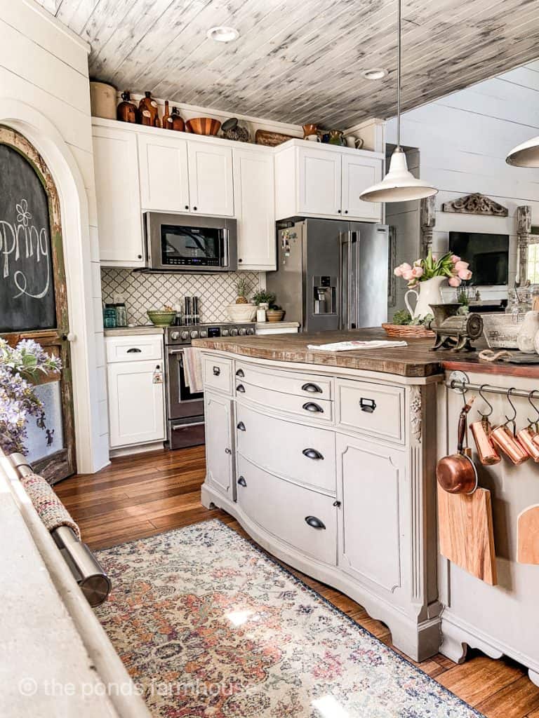 Repurposed Furniture for DIY Kitchen Island for a modern farmhouse feel.  Colorful rug and vintage copper.