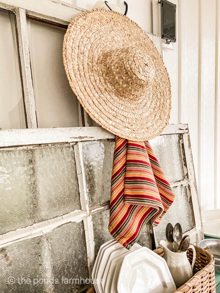 Cinco de mayo Table Decorations. Mexican style straw hat used in Cinco de mayo decorations. Ironstone pitcher with vintage spoons.