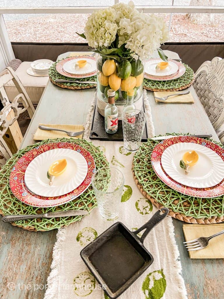 Cinco de mayo party table setting. Vintage silverware, cast iron skillet. Dos Equis salt and pepper shakers and hand stamped table runner.