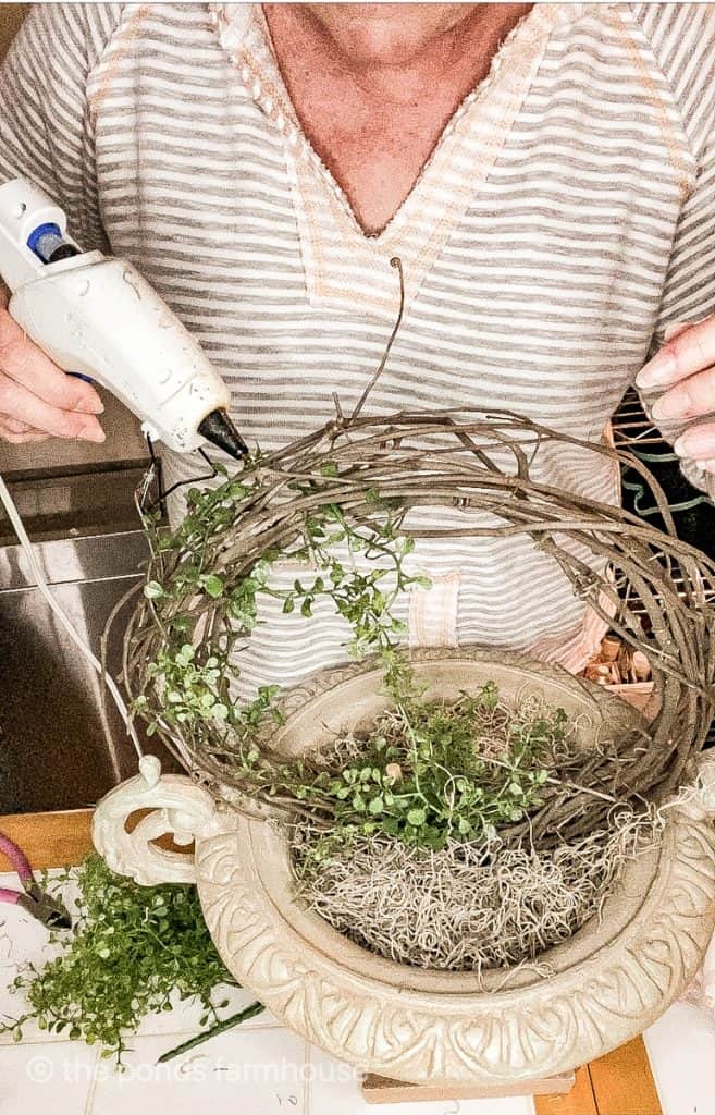 How to make a Topiary by attaching the faux stems to the grapevine wreath with hot glue.