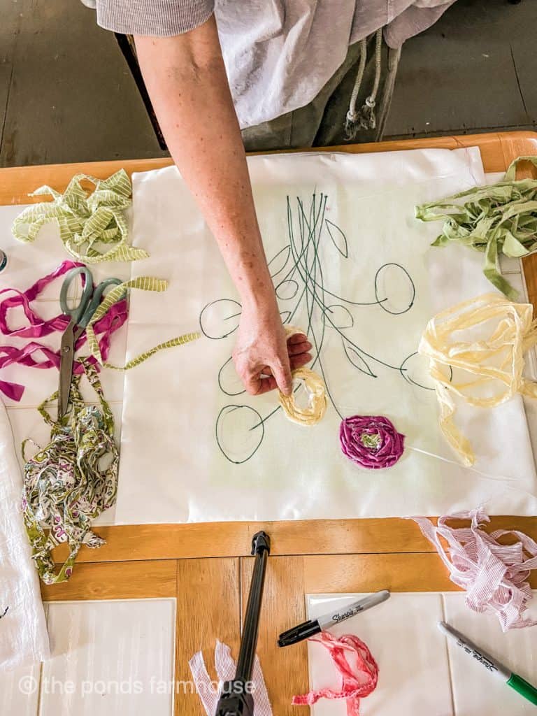 Twist scrap fabric to make individual flowers on the Spring Pillow Cover