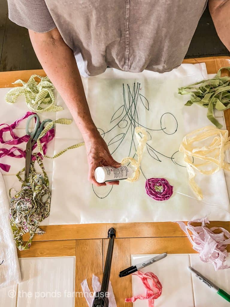 Use fabric glue to adhere scrap fabric to pillow cover to make SPring Farmhouse Style Pillow