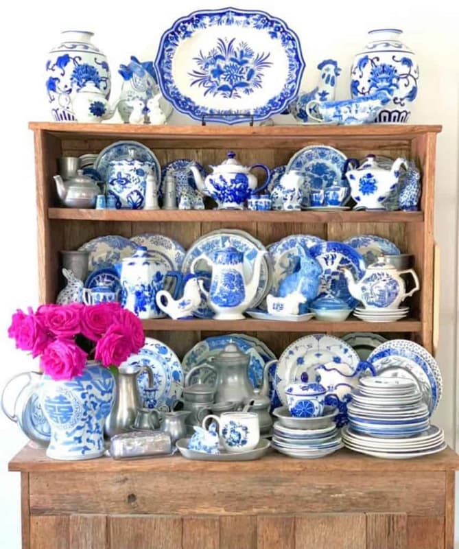 Vintage blue and white dishes displayed on step back hutch