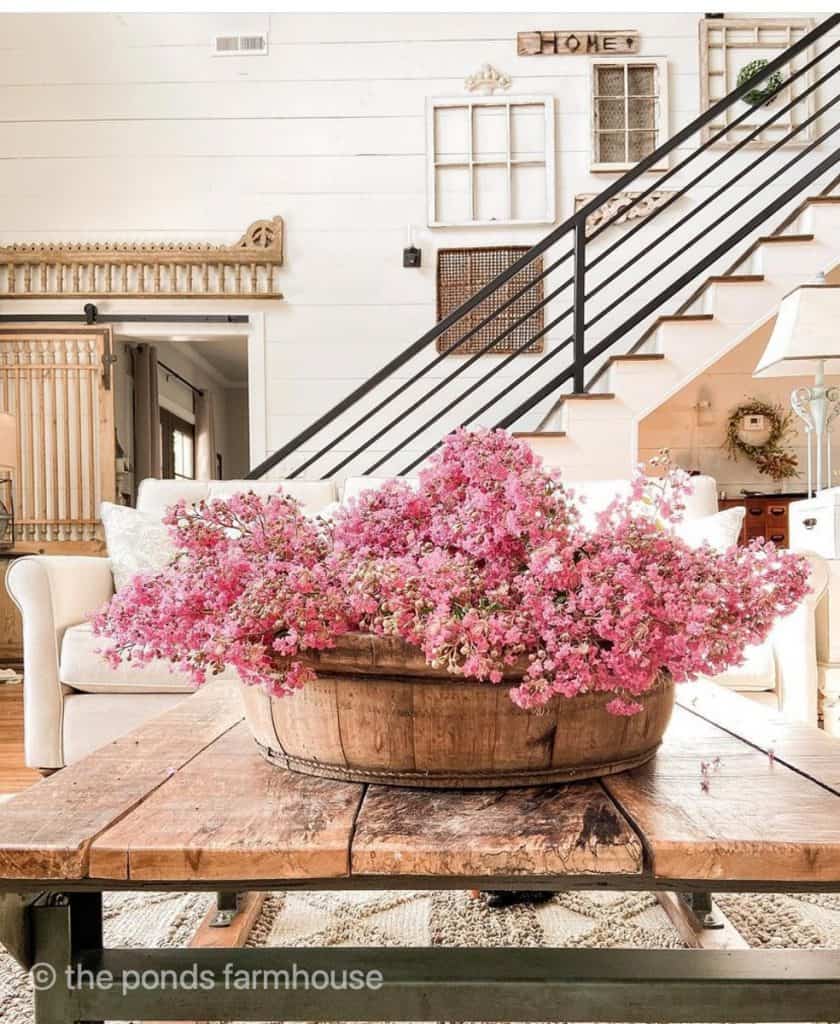 Fresh Flowers in wooden bowl to decorate a coffee table in a modern farmhouse.