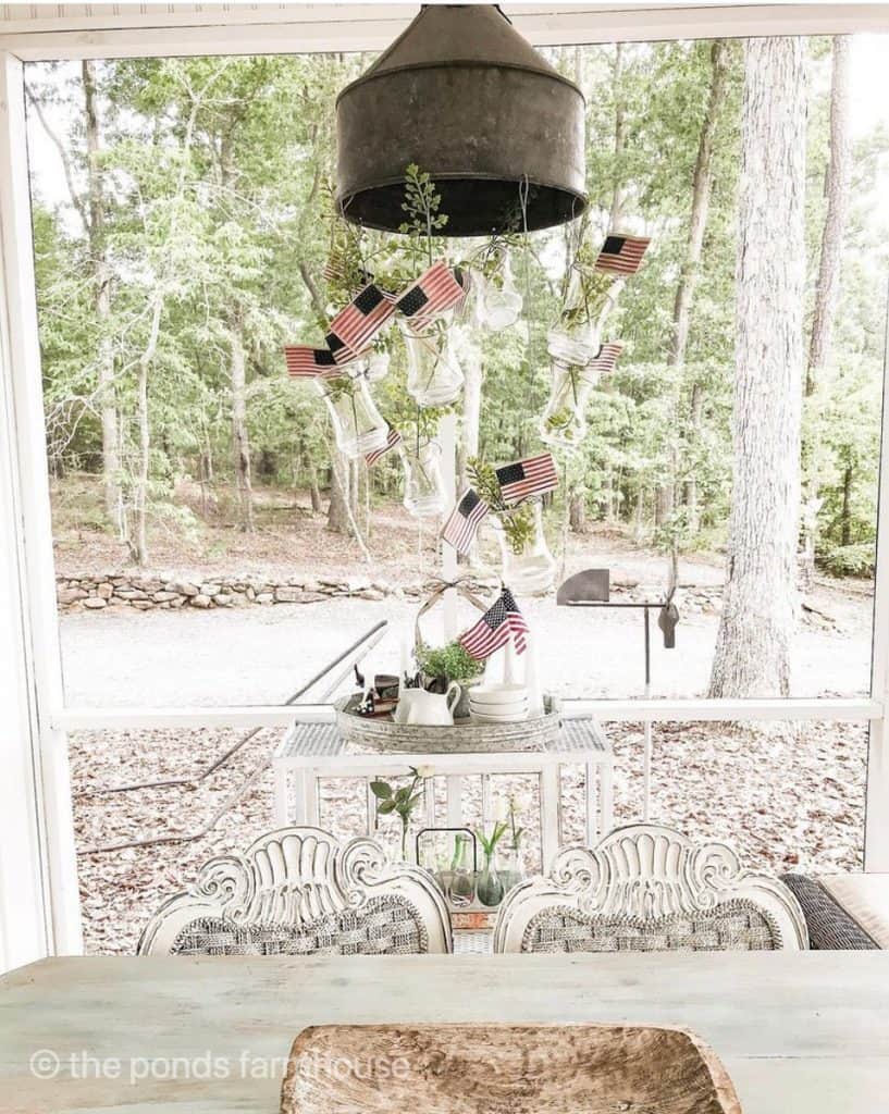 DIY mini flags in vases hanging from DIY funnel light fixture for memorial day and 4th of July