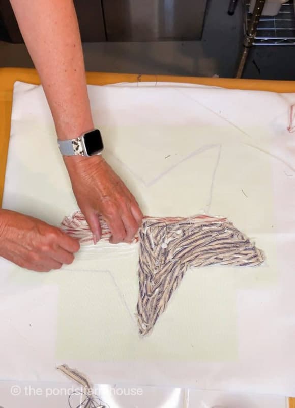 adding ticking fabric scraps to pillow cover for patriotic star pillow