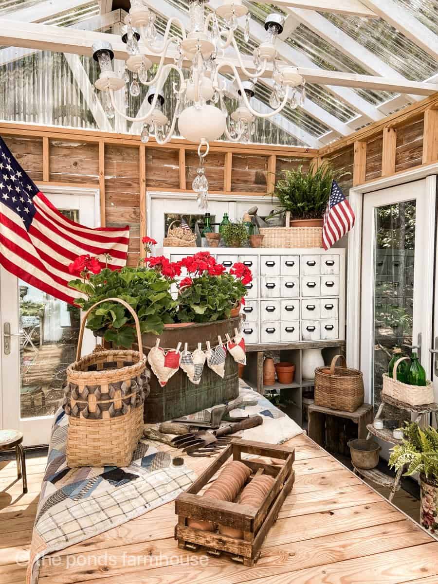 Patriotic She Shed Tour with antique flag and DIY apothecary cabinet - several thrifted baskets on display.