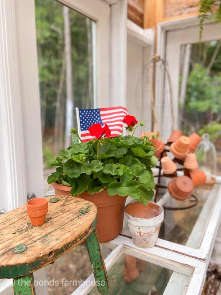 Potting table in green house filled with DIY aged clay pots.  