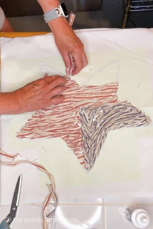 adding ticking fabric scraps to make star pillow for 4th of July