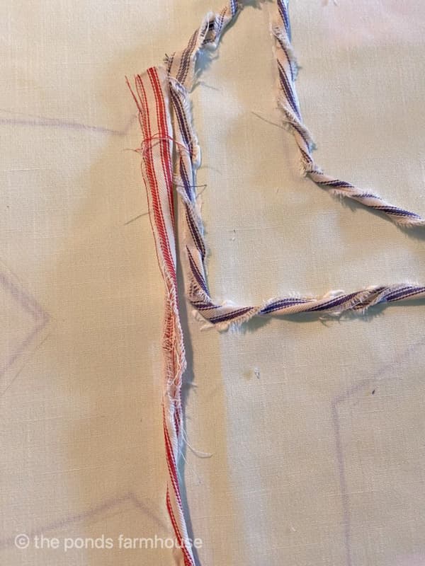 twisting ticking fabric scraps to make 4th of July Pillow Cover