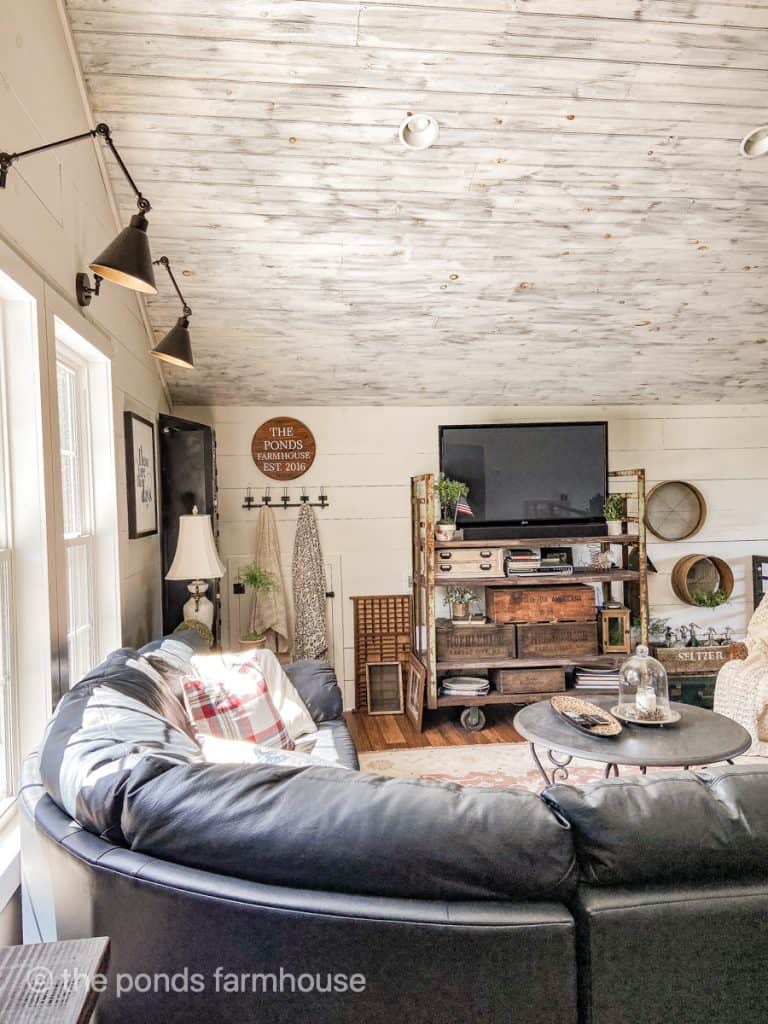 Industrial loft is filled with vintage collections and a leather sectional sofa.