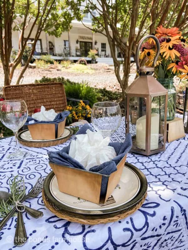 Picnic place setting with wooden fruit crates holding sandwiches