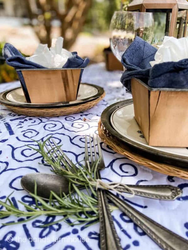 Picnic place setting with wooden fruit crates & rosemary wrapped cutlery