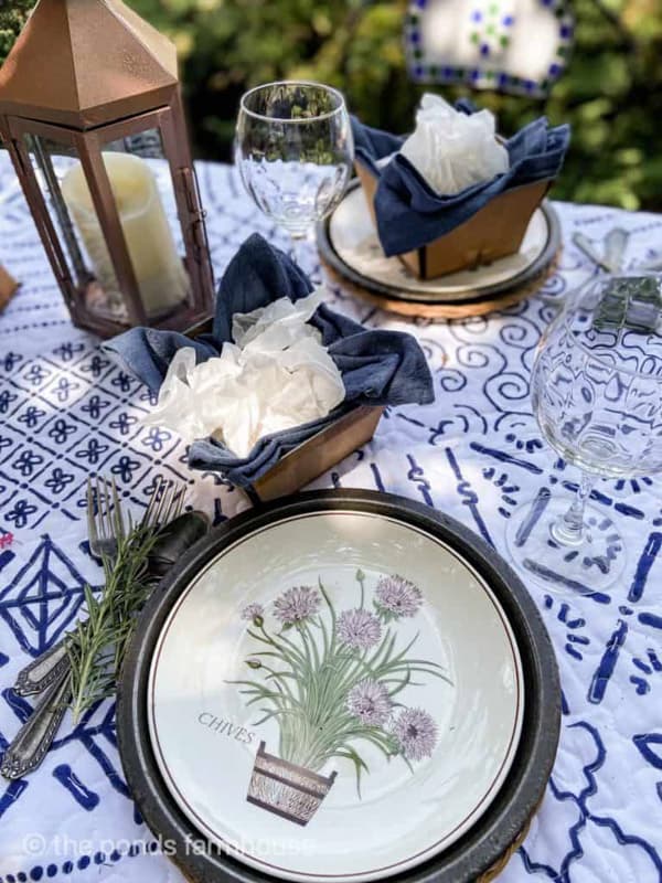 Picnic table setting with herb plates & fruit crates on a quilt tablecloth