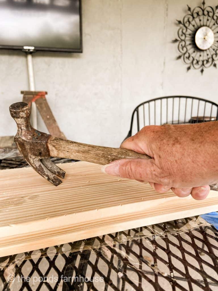 Use hammer to make wood look old for address sign.