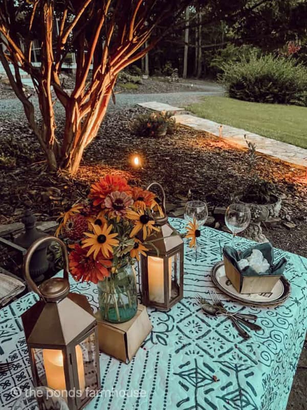 copper outdoor landscape lighting around picnic table setting