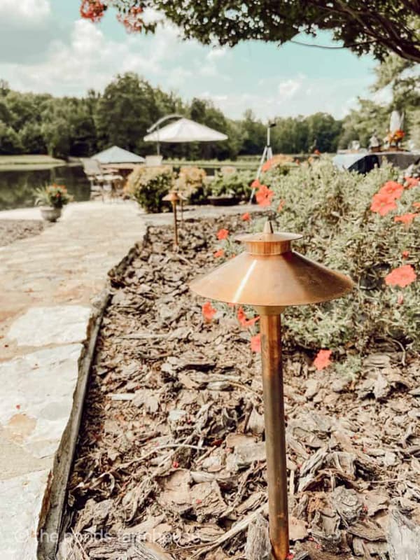 copper outdoor landscape lighting around pool and gazabo