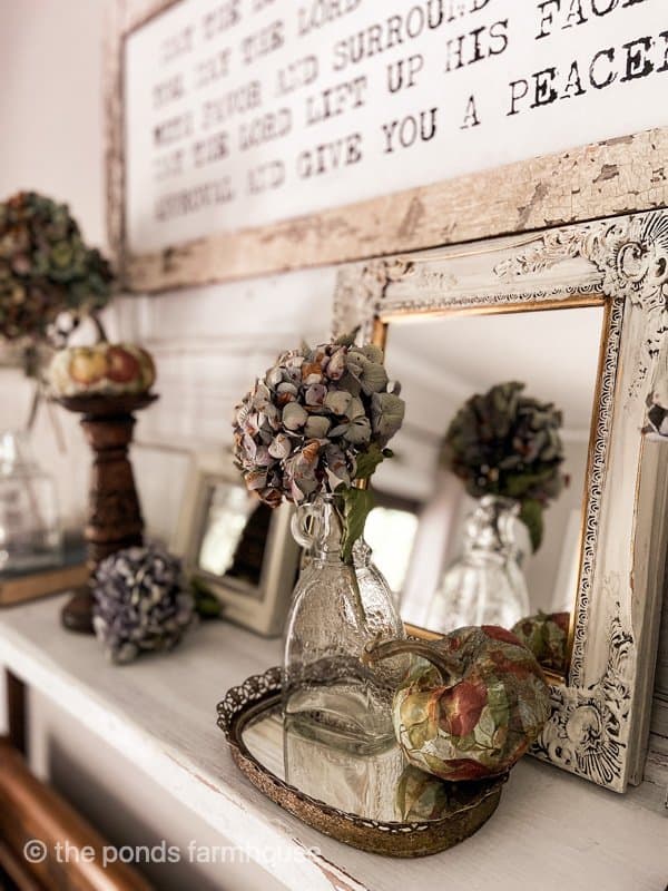 Dried Hydrangeas, decoupaged pumpkins decorate the repurposed vintage mantel for fall. 