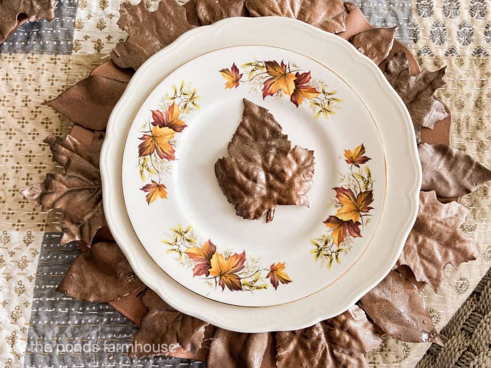 Fall Leaf in center of golden leaves dessert plate on fall table.  