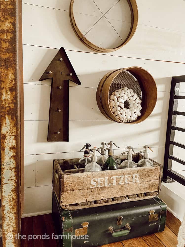 Vintage rustic collections of seltzer bottle and old sifters.  Industrial Farmhouse Decor
