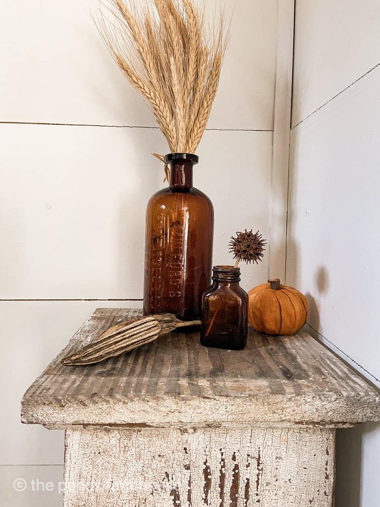 Thrift Store Amber Bottles are great for Fall Decorating
