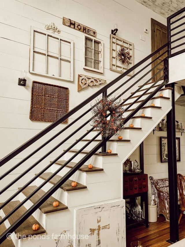 Salvaged Architecture old windows for a staircase gallery wall with industrial black railings.  