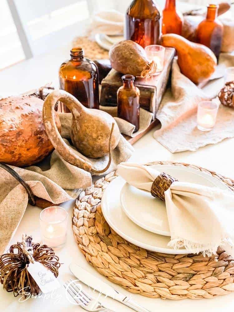 Fall gourds, amber bottles for a Thanksgiving Table Centerpiece.