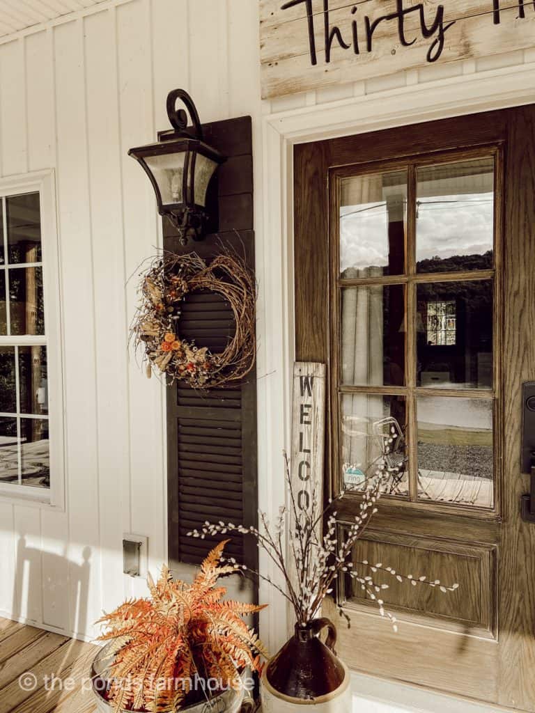 DIY Door Shutters on Farmhouse Front Porch and Decorated for Fall with grapevine wreaths