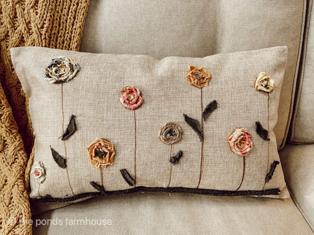 Easy decorative pillow cover made using scarp fabric and fabric glue.  Perfect farmhouse design for fall.