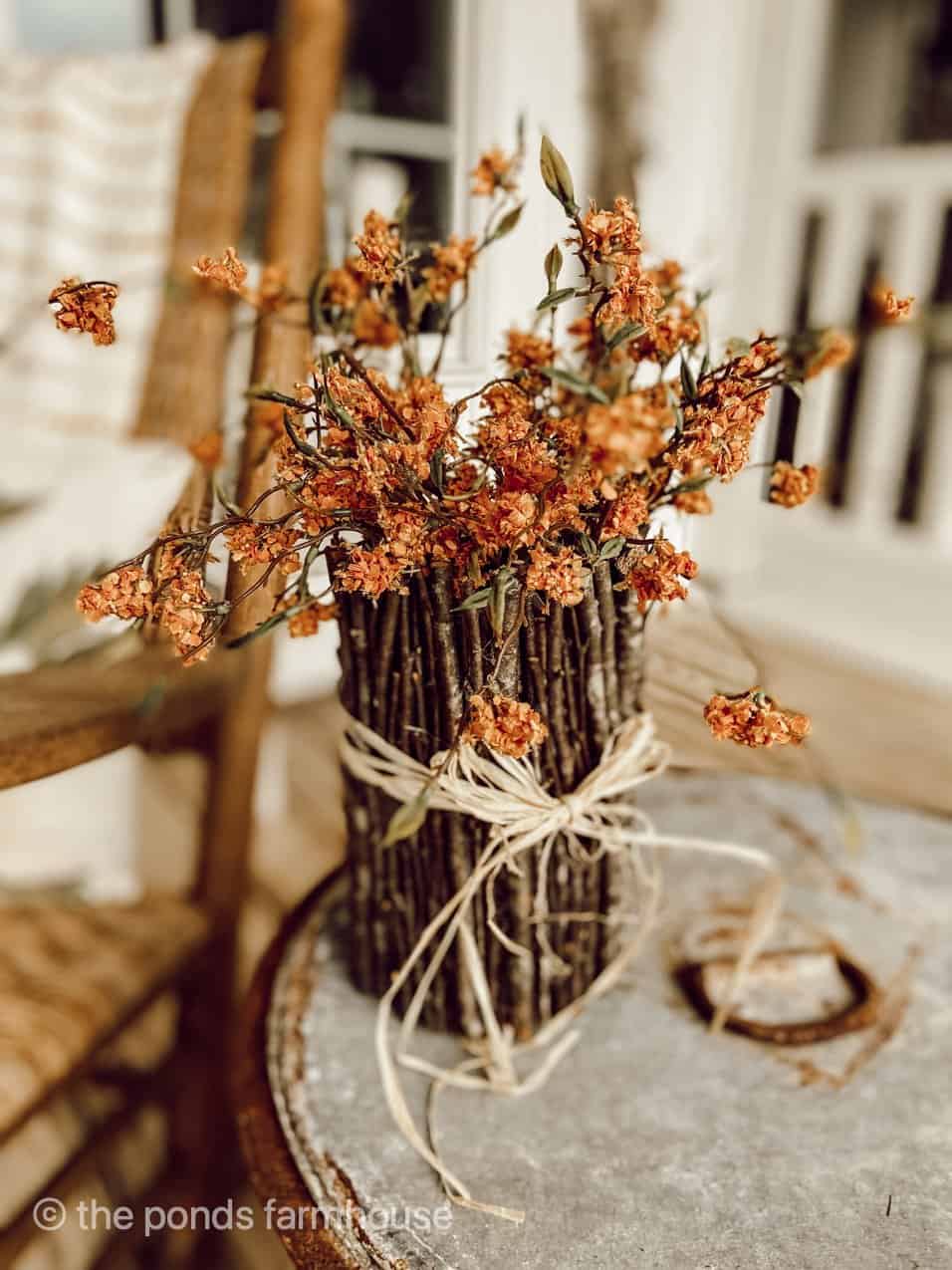 Recycled tin can twig vase with fall flowers