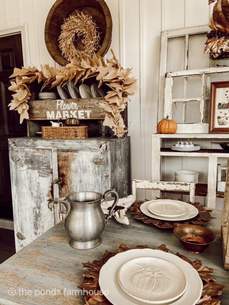 DIY Fall Leaf Garland displayed on a shelf. Easy Fall Craft for cheap decoratiing.