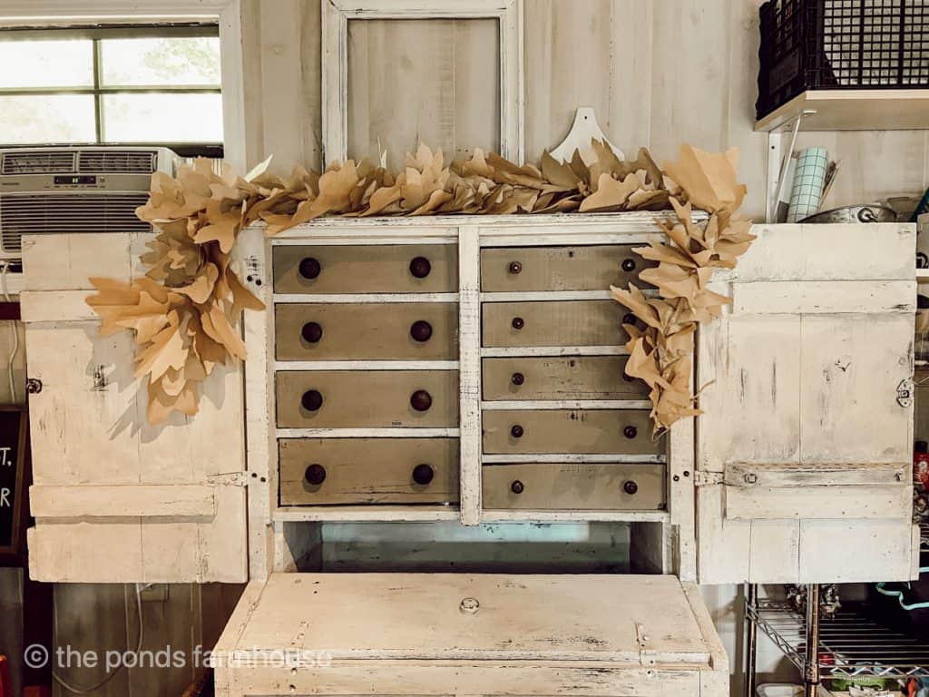 DIY Fall Leaf Garland displayed on a cabinet. Easy Fall Craft